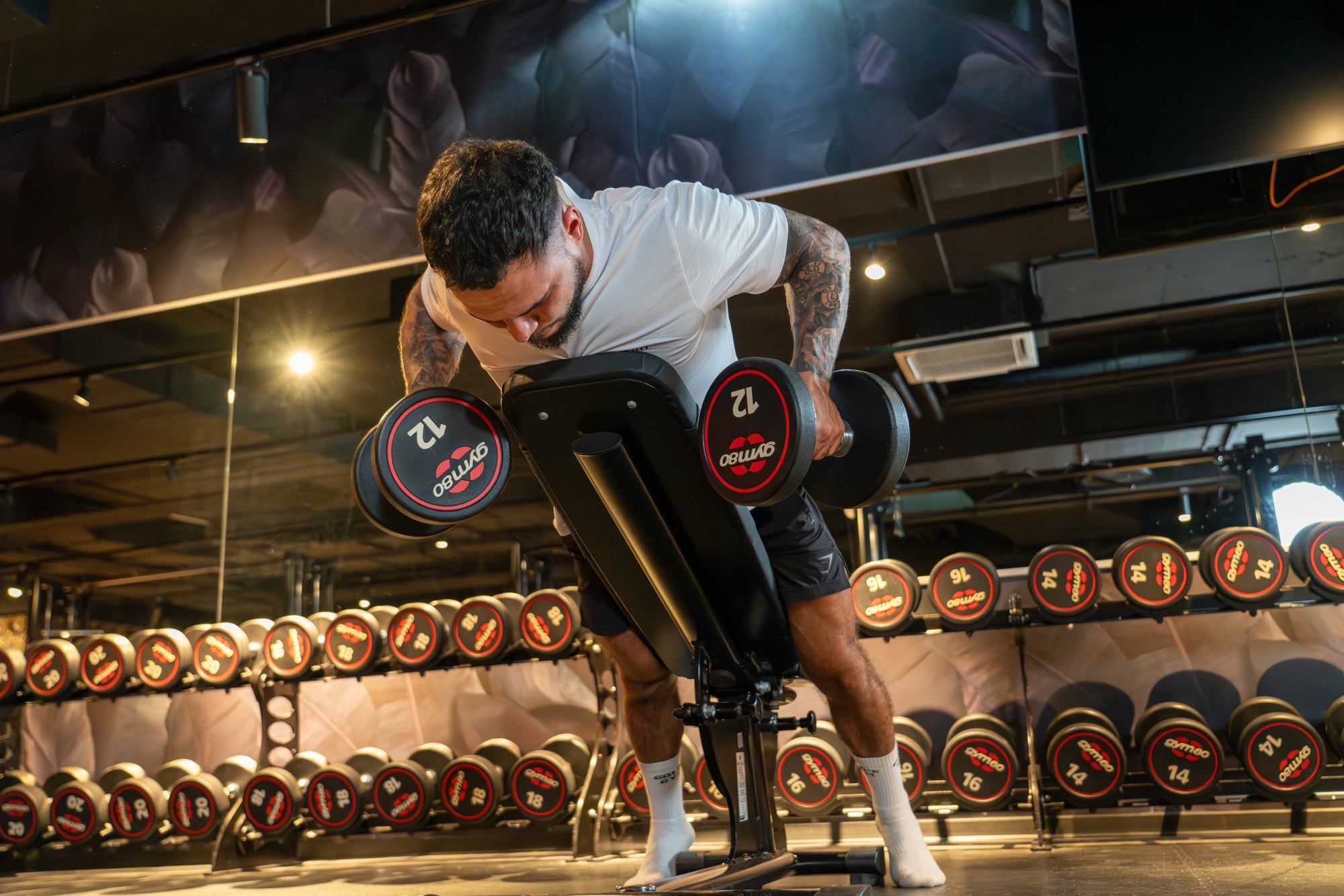 An athlete executing a dumbbell row on an incline bench, emphasizing proper alignment and upper back activation, in line with StrengthLab360’s training methodology.