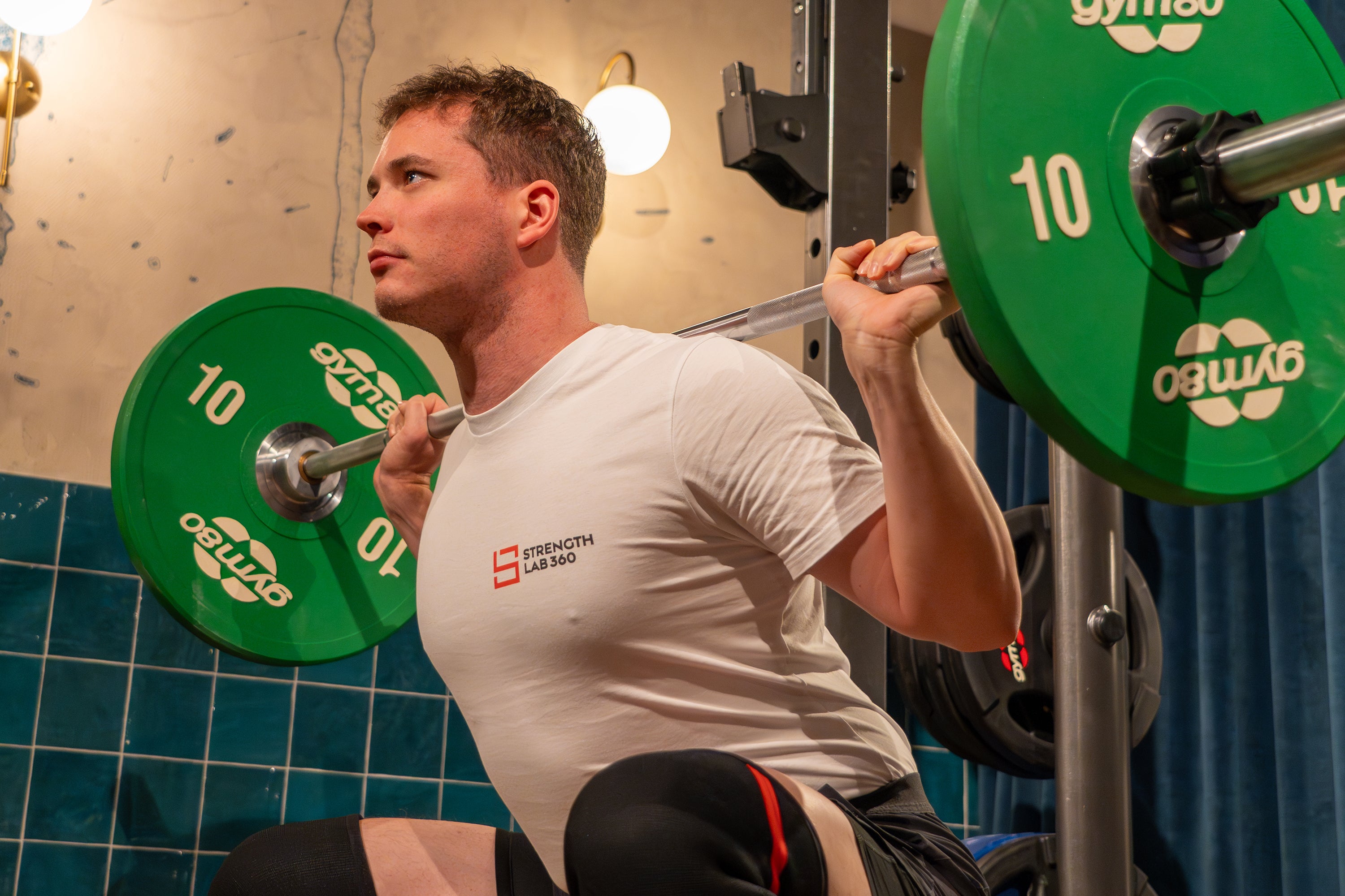 The StrengthLab360 Head Coach demonstrating proper squat technique, focusing on form, depth, and muscle engagement, to inspire optimal performance in strength training.