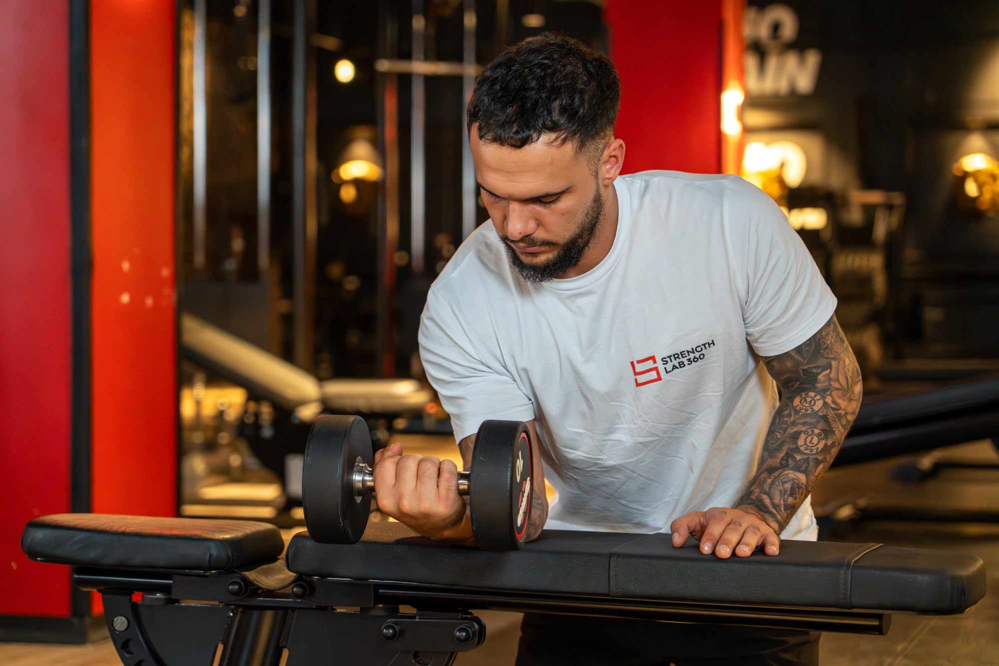 An athlete performing a wrist curl with focused movement to target forearm muscles, aligned with StrengthLab360’s detailed strength training techniques.